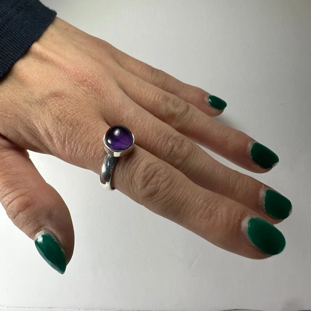 Sleek silver amethyst ring with deep purple cabochon gem