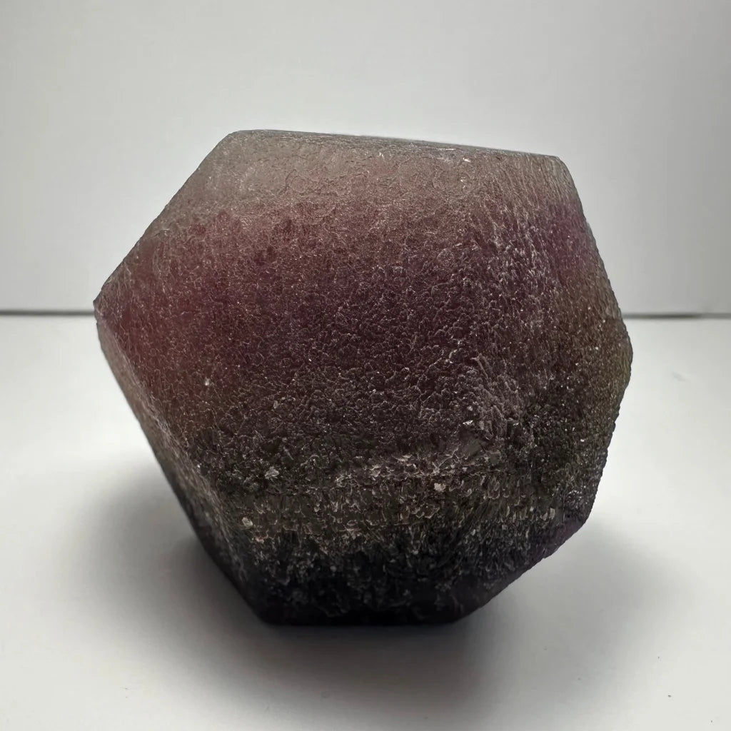 Stunning purple fluorite dodecahedron crystal geode with hexagonal translucent texture