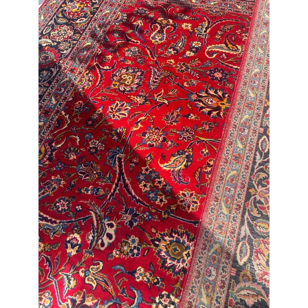 Vibrant red Persian rug with intricate floral patterns in navy, gold, cream