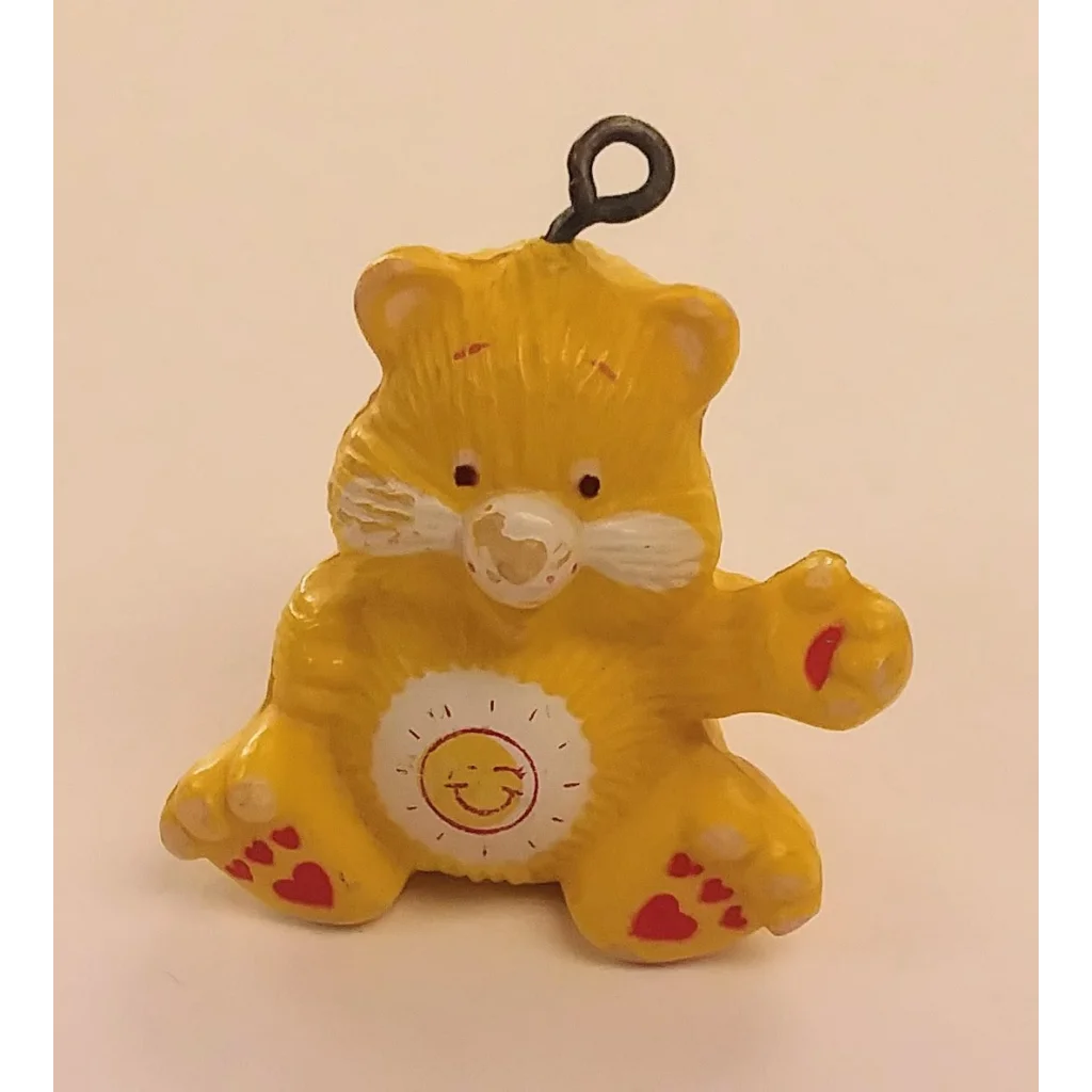 Cute yellow Care Bears keyring charm with heart accents and smiling sun