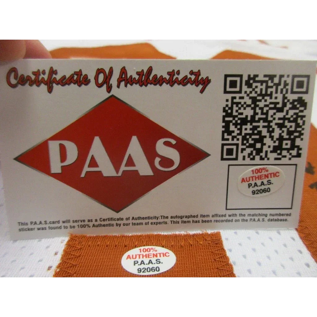 White card with orange diamond logo and QR code certifying Texas Longhorns signed autographed football