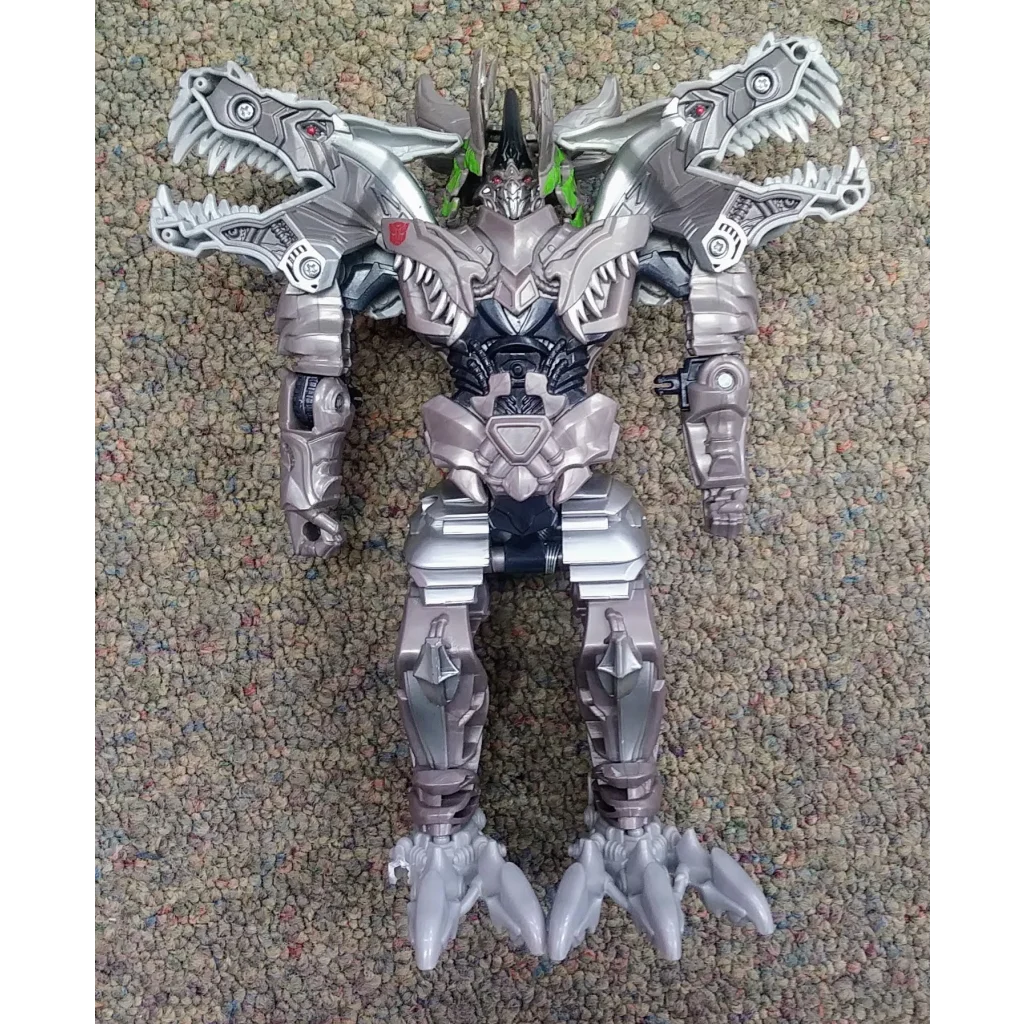 Silver and black Transformers action figure Dinobot Grimlock with metallic finish