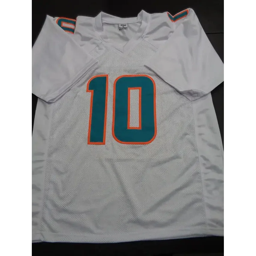 White Miami Dolphins autographed jersey with teal and orange trim and number 10 Tyreek Hill