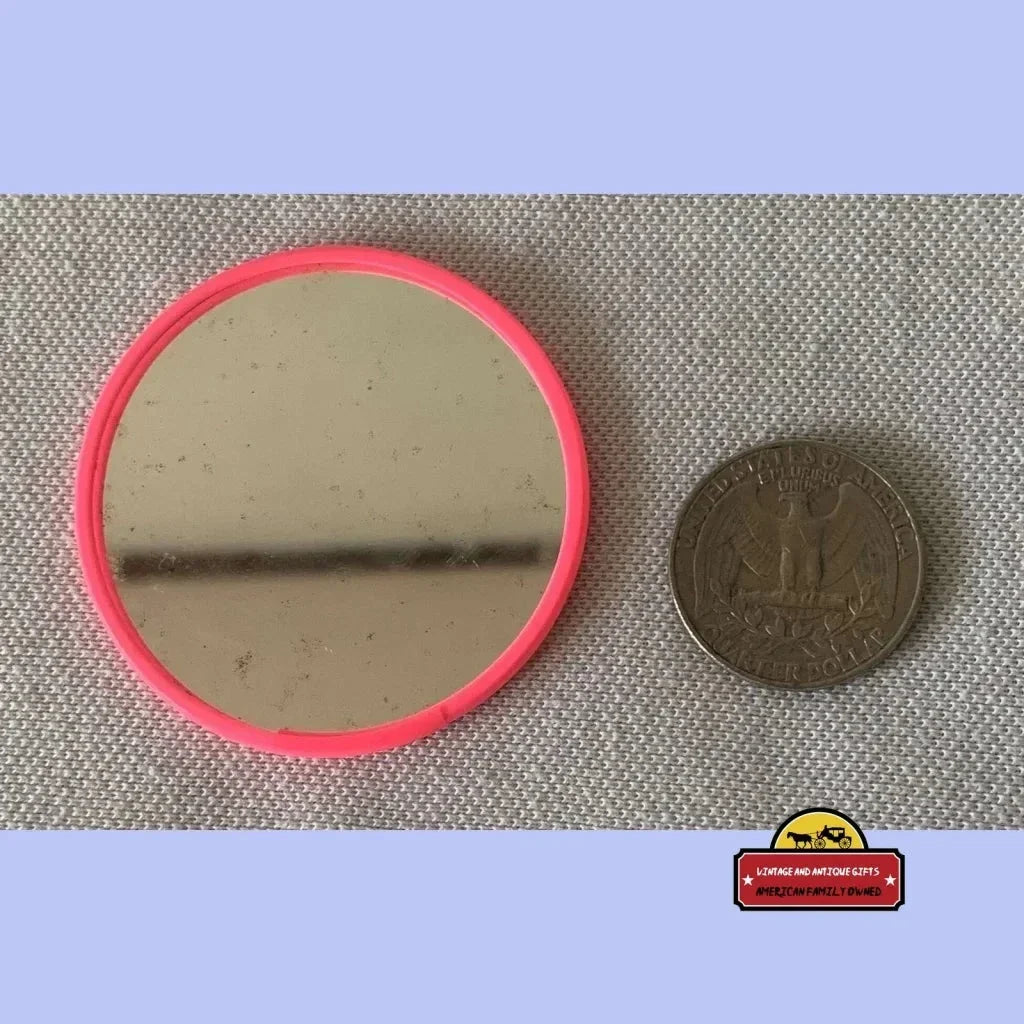 Circular pink plastic frame pocket mirror featuring Audrey Hepburn vintage collectible design