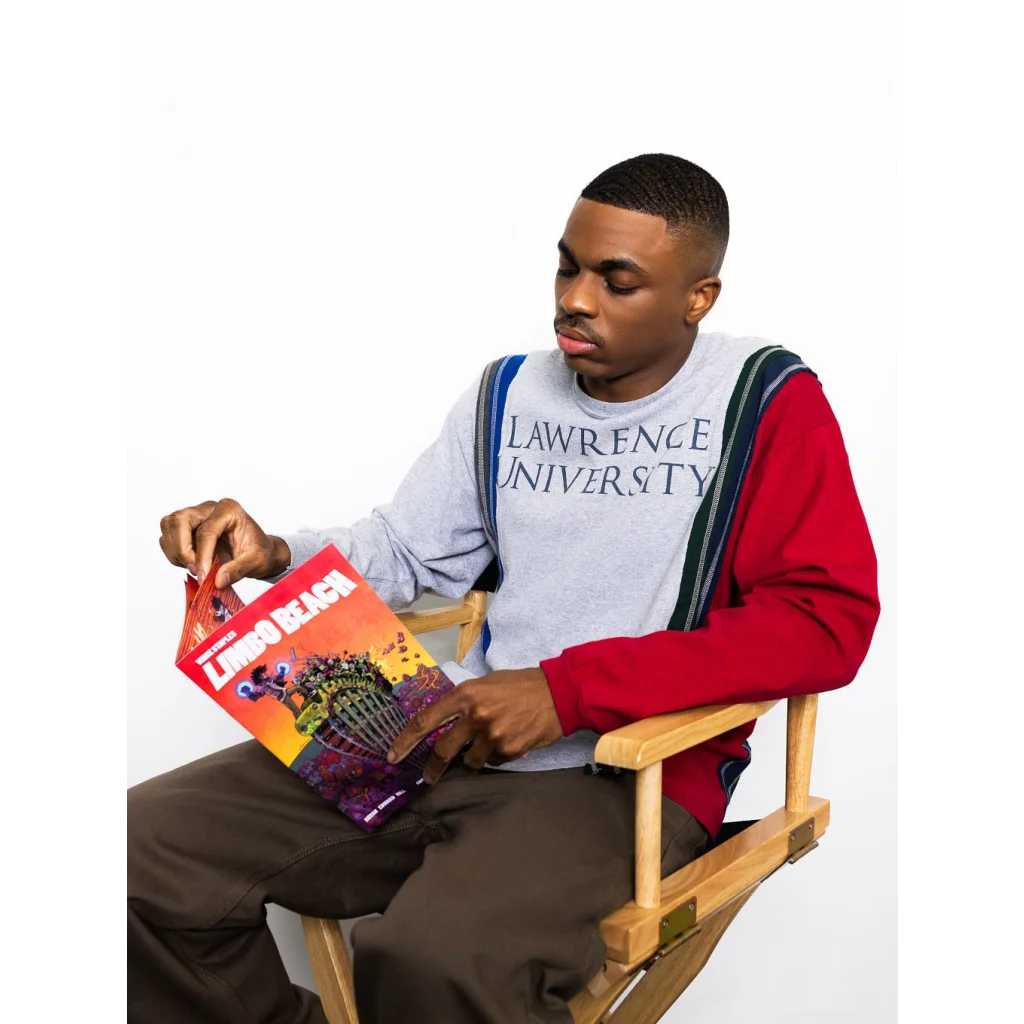 Young man in colorful shirt reading Vince Staples graphic novel by Chris Robinson and Bryan Edward Hill