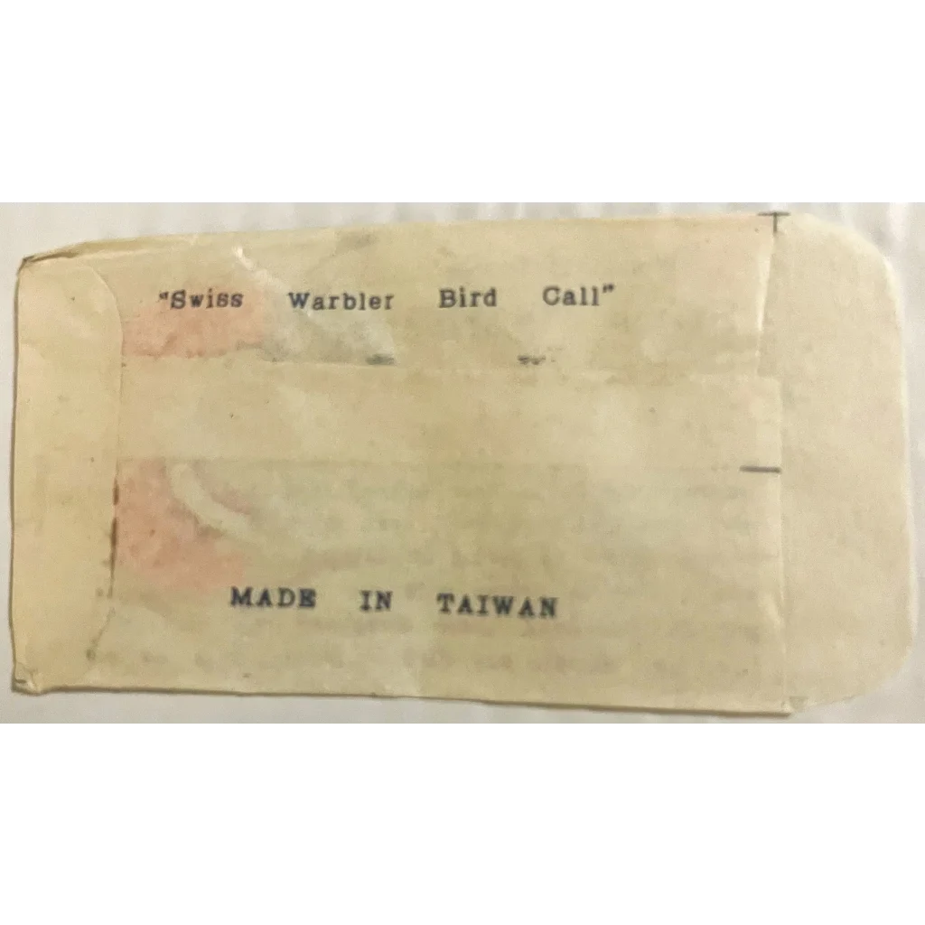 Label with text about Swiss Warbler Bird Call made in Taiwan for vintage product