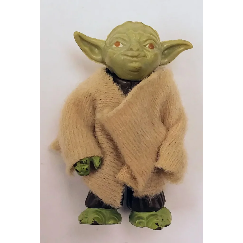 Vintage Star Wars action figure Yoda with beige robe and green skin