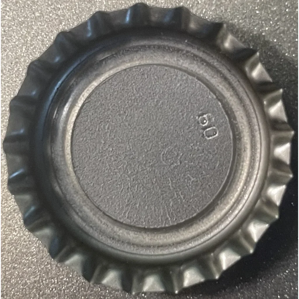 Vintage Nehi Grape bottle cap from the 1980s featuring a ridged edge and flat center