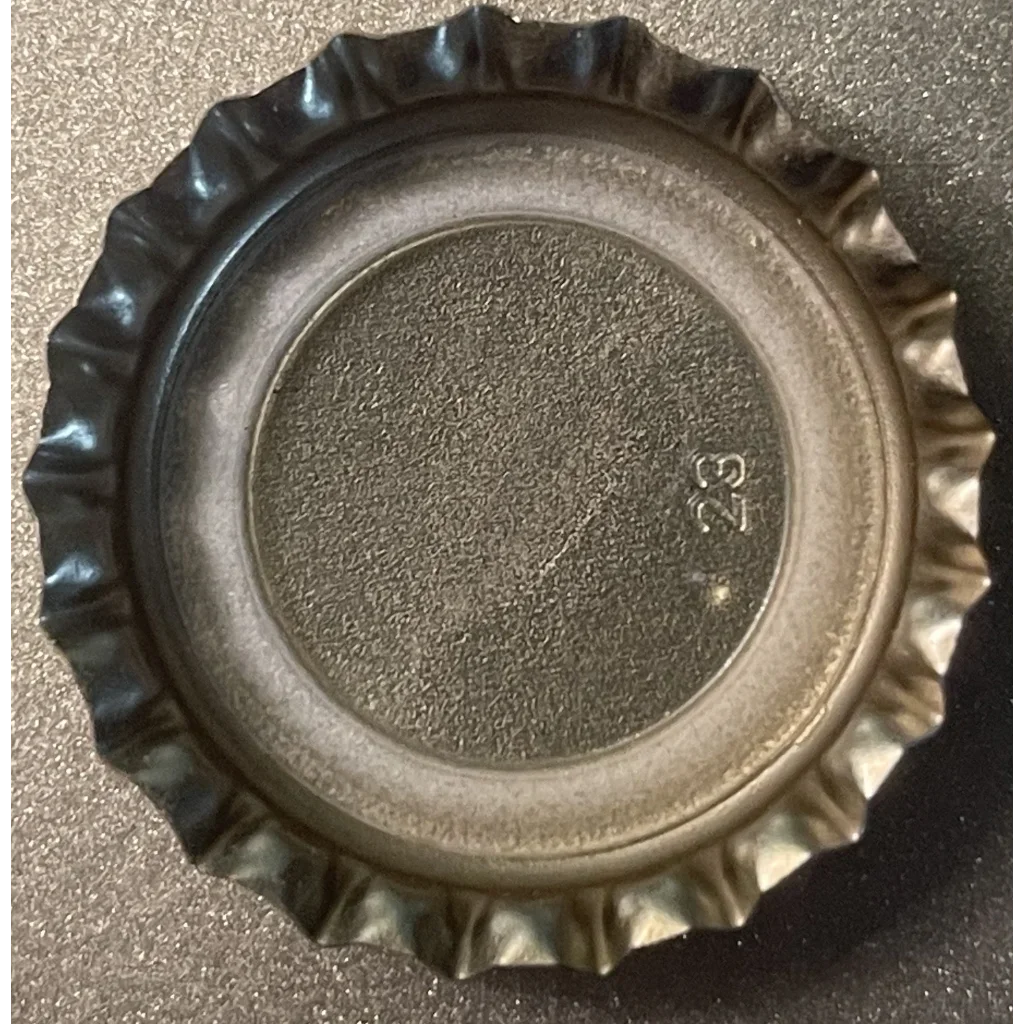 Metal bottle cap with a fluted edge from a vintage Sunkist Orange Soda collectible