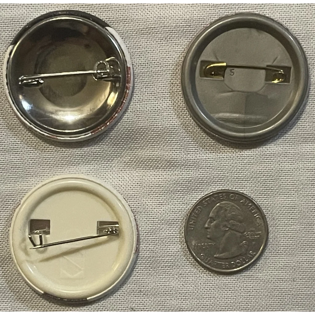 Button pins of California Raisins in assembly with a quarter for size comparison