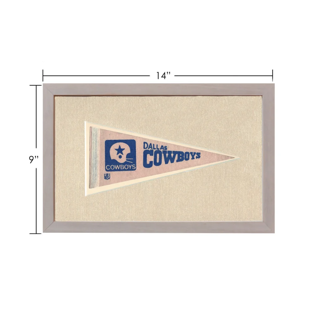 Vintage Dallas Cowboys pennant in frame with beige background