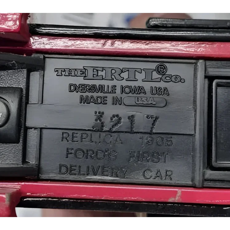 Underside of vintage ERTL die cast coin bank featuring 1905 Ford Delivery Truck
