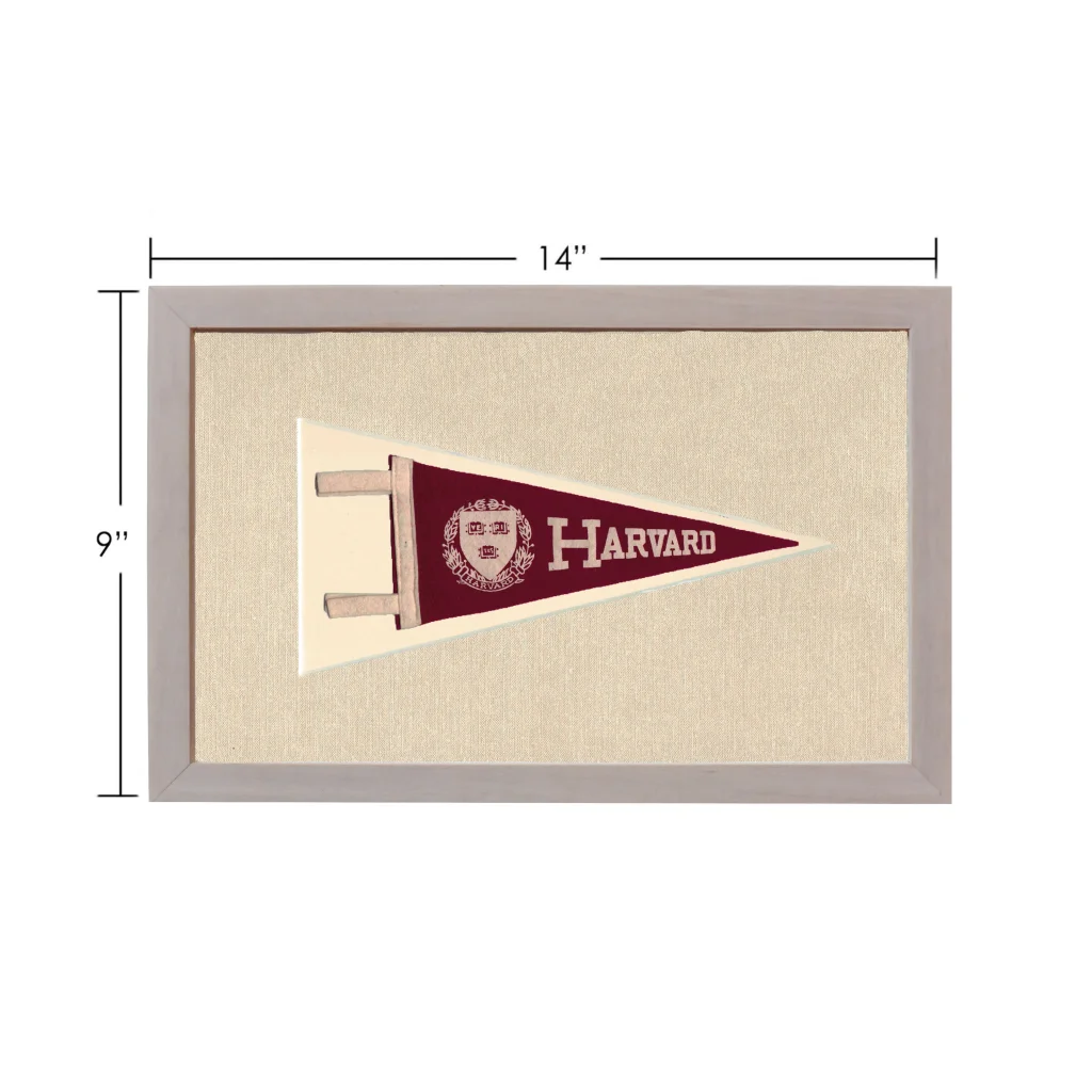 Vintage Harvard pennant in maroon with white lettering, framed on beige background