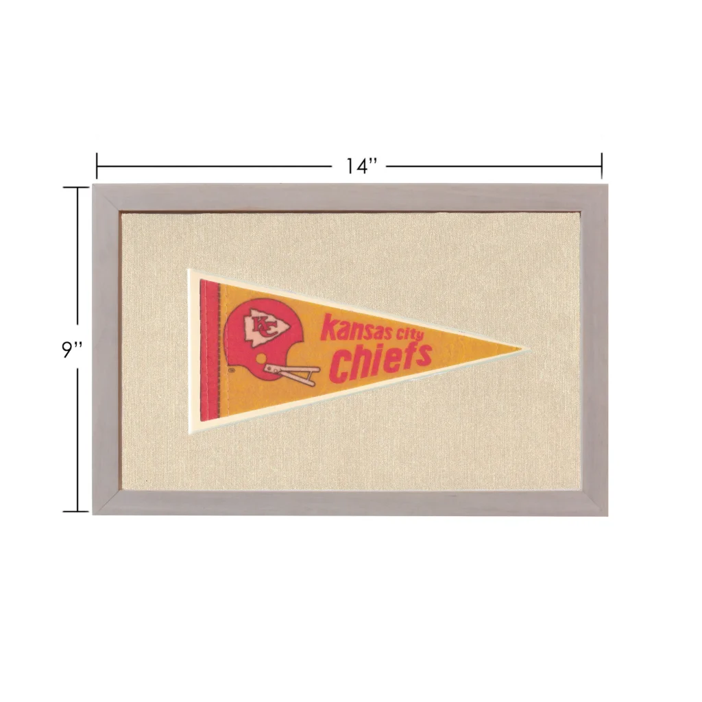 Vintage Kansas City Chiefs pennant framed on textured beige fabric