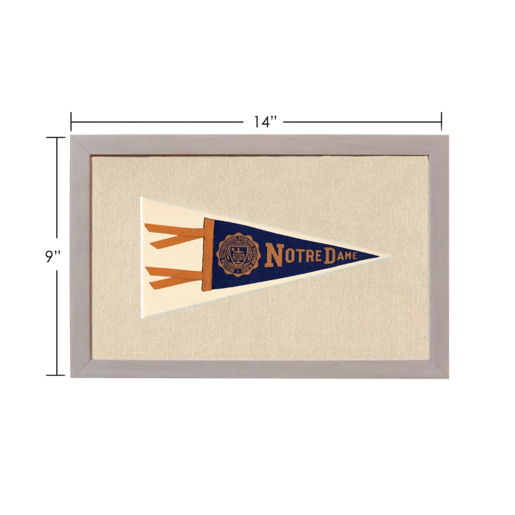 Vintage Notre Dame pennant in navy blue and cream with gold lettering, framed