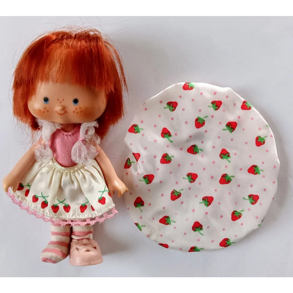 Vintage Strawberry Shortcake doll in ballerina outfit with red hair and cream dress