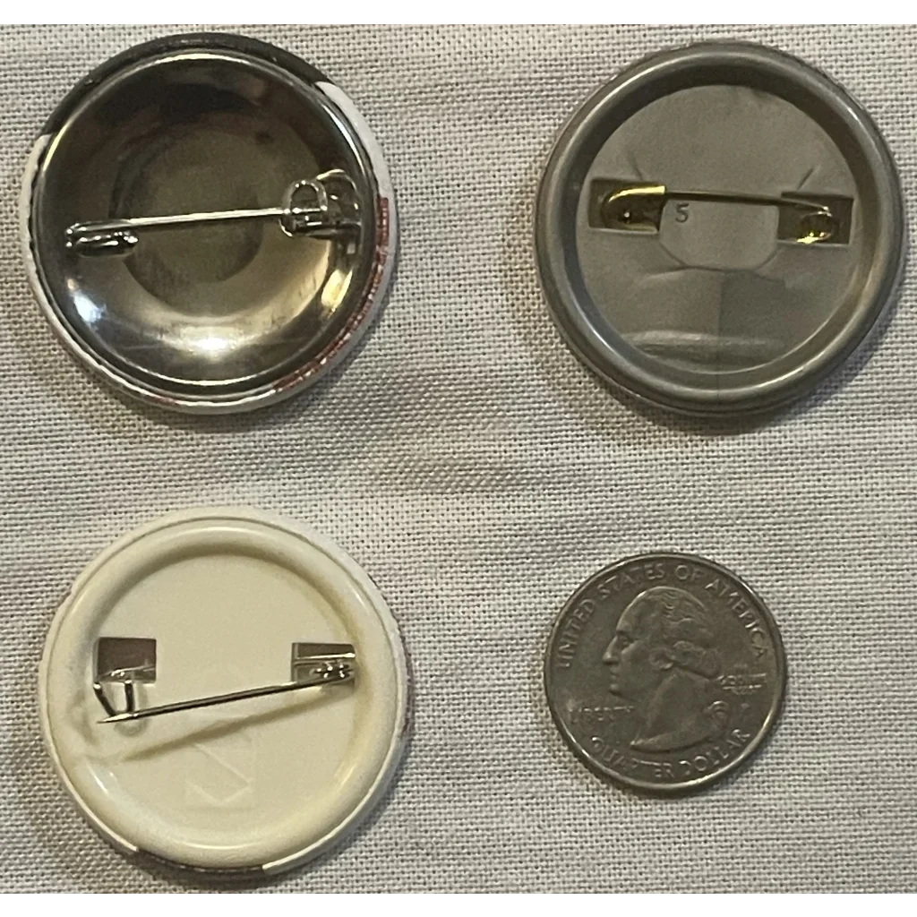 Button pin backs in cool styles with a quarter for size next to Mutant Ninja Turtles pin