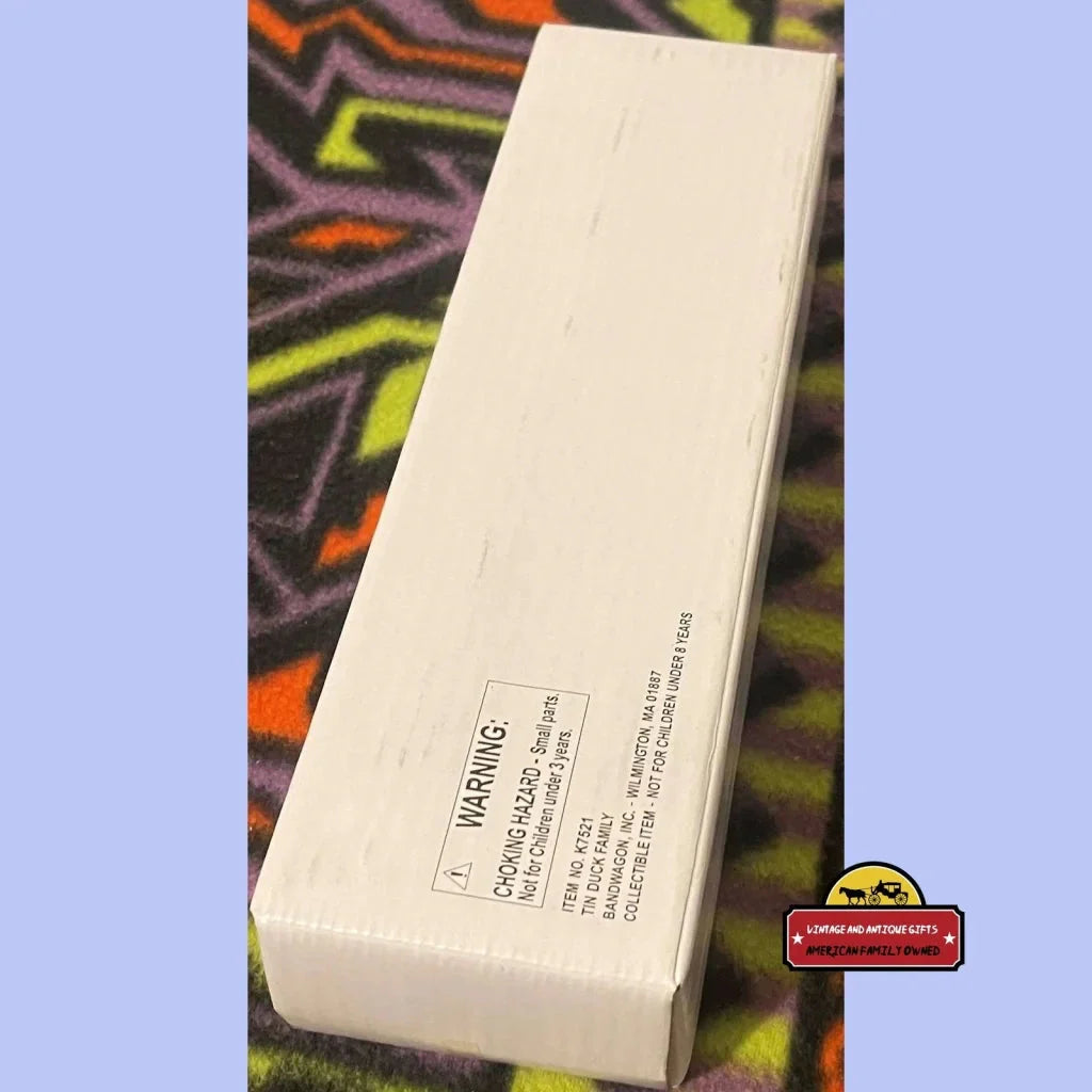 White rectangular box with text, showcasing the Rare Vintage Tin Wind Up Duck Family Toy