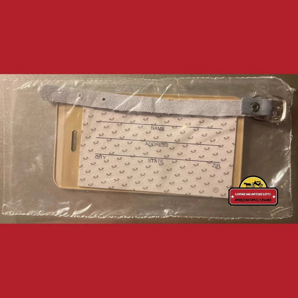 Protective phone case with heart pattern next to Disney World Mickey Mouse luggage tag