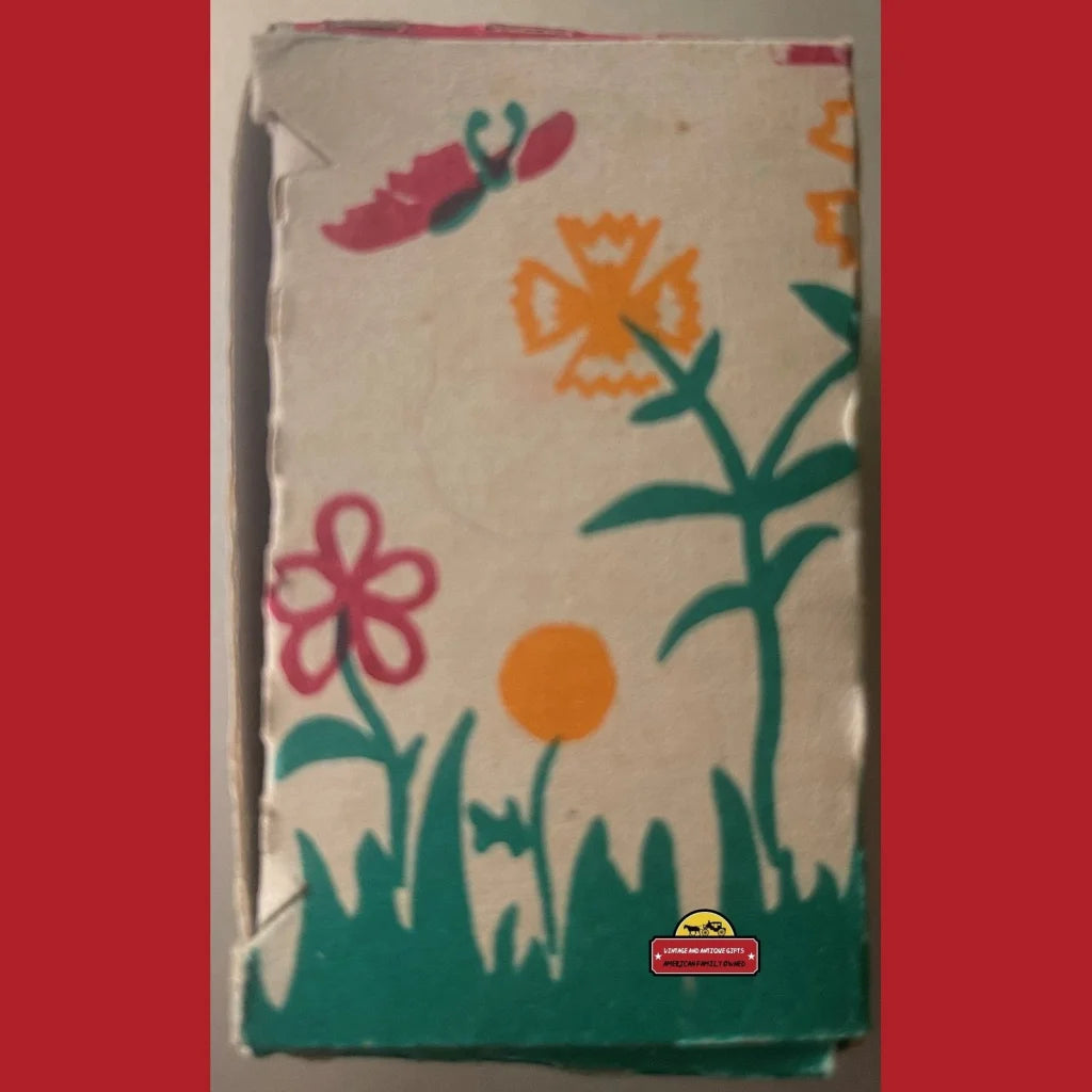 Colorful floral tea towel next to a Rare Vintage Tin Wind Up Pecking Chicken Toy