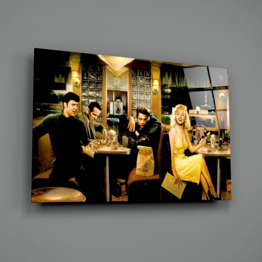 Glass wall art mounted on gray wall depicting five people in a 1950s diner scene with woman in yellow dress prominently featured on right side.