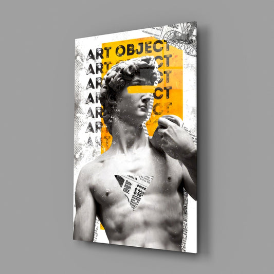 Glass wall art displaying a classical marble statue bust with yellow geometric shapes and repeated "ART OBJECT" text, angled three-quarter view against gray background.