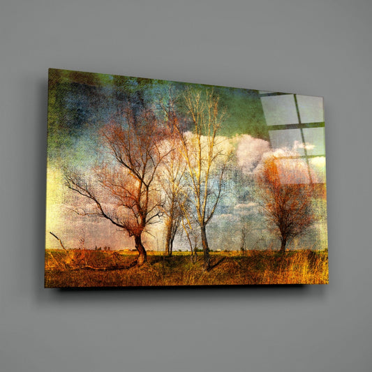 Canvas wall art displaying bare autumn trees in golden and rust tones with green sky, mounted at an angle against gray wall.