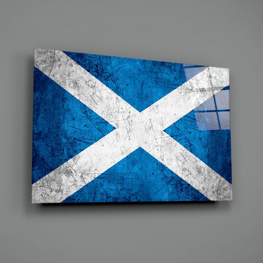 Scratched metal Scotland flag with white X on blue background displayed as angled glass wall art against gray wall.