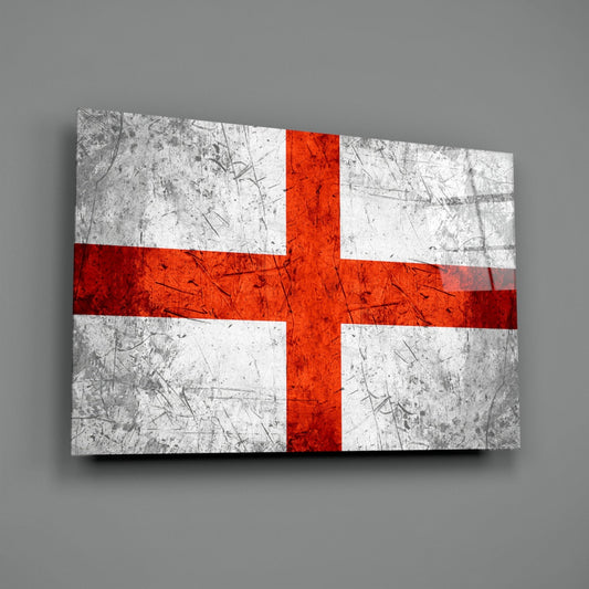 Angled perspective view of a rectangular glass panel displaying the England flag with red cross on white background and distressed metal texture, mounted on gray wall.