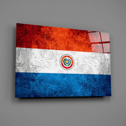 Angled three-dimensional view of glass wall art displaying Paraguay's flag with horizontal red, white, and blue stripes, centered seal, and scratched metal texture effect.