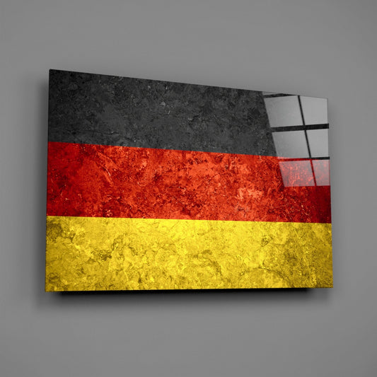 German flag wall art with black, red, and yellow horizontal stripes and textured stone surface, angled three-quarter view.
