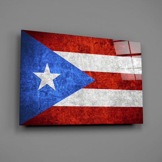 Puerto Rico flag glass wall art with blue triangle, white star, and red-white horizontal stripes displayed at angle against gray background.