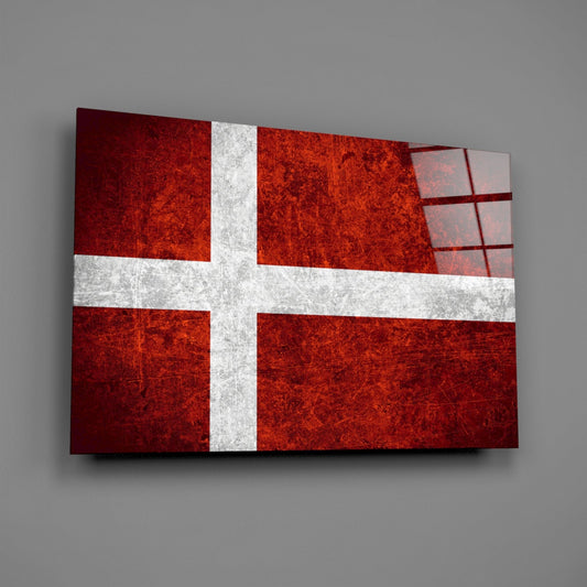 Deep burgundy and white Danish flag on glass panel displayed at an angle against gray background.