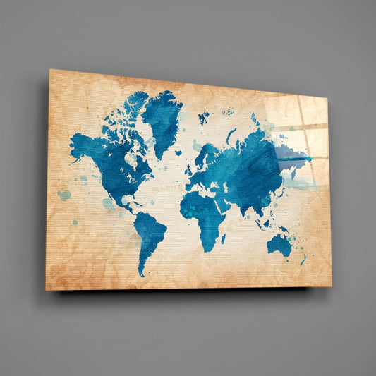 Blue watercolor world map on cream kraft paper mounted on wood-grain glass panel, angled view against gray background.