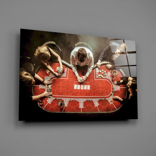 Overhead view of poker players seated around a red table with cards and chips, printed on glass wall art panel.