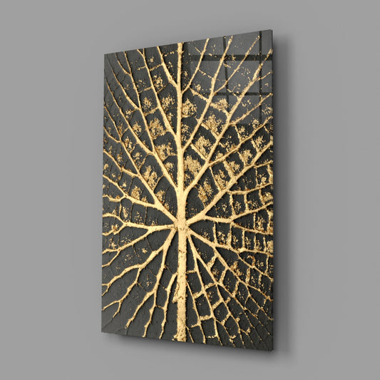 Angled perspective view of a rectangular black glass panel with gold leaf vein pattern radiating from center, displayed against gray background.