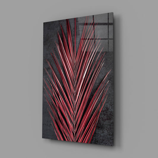 Angled perspective of glass wall art displaying crimson red neon lines radiating in V-shape against dark textured background.