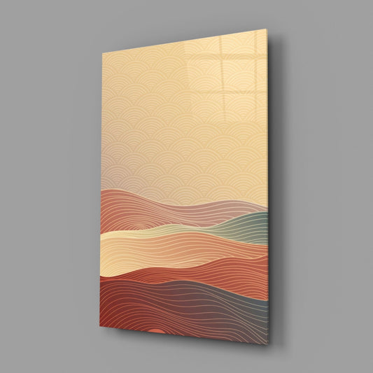 Angled perspective view of a glass wall art panel displaying layered wavy lines in terracotta, cream, sage, and dark red tones against gray background.