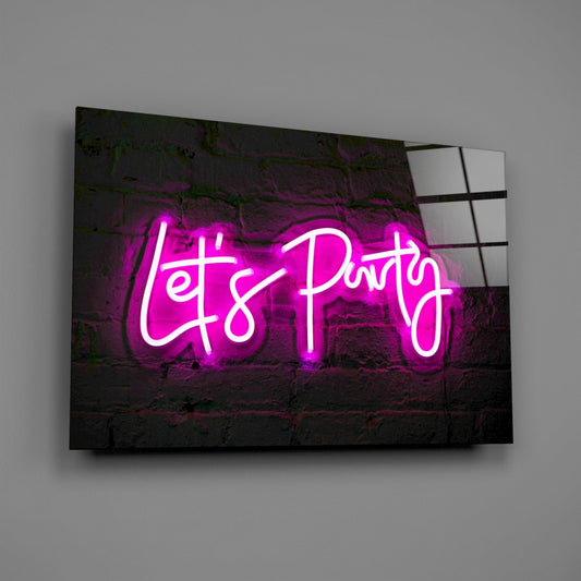 Magenta neon "Let's Party" text glowing against dark brick wall mounted on glass panel, angled three-quarter view.