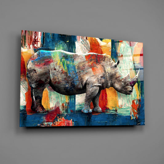 A rhinoceros in profile against a vibrant abstract background of blue, red, orange, and yellow paint strokes on glass.