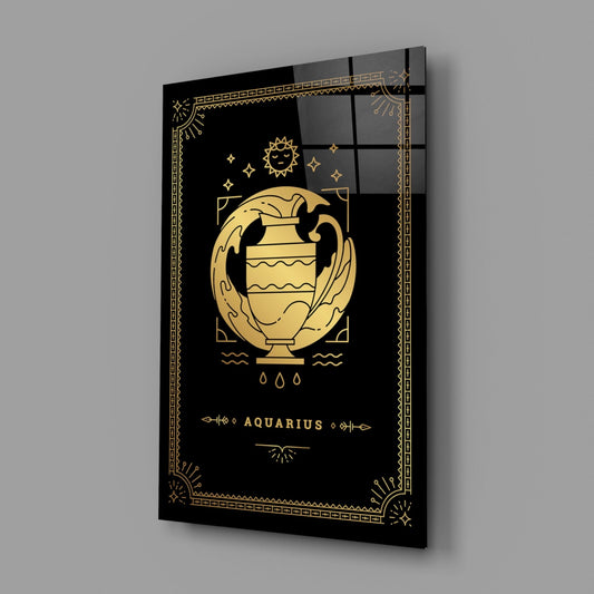 Black glass wall panel with gold Aquarius zodiac symbol, urn illustration, sun, stars, and decorative geometric border, angled perspective view.