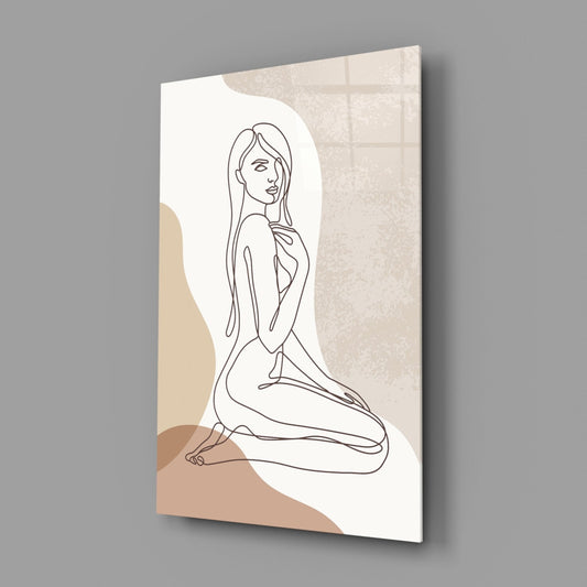 Glass wall art displaying a line-drawn kneeling woman with beige and tan abstract shapes against white background, angled perspective view.