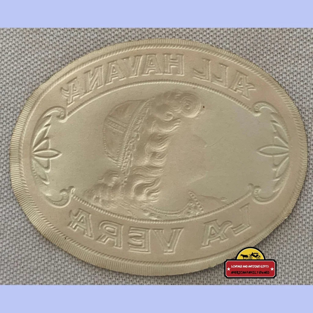 Oval embossed seal on the Rare Antique La Vera Cigar Label showcasing a vintage design