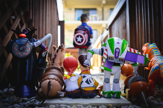 Iconic 90s toys including action figures handheld games and colorful playsets representing vintage collectibles from the 1990