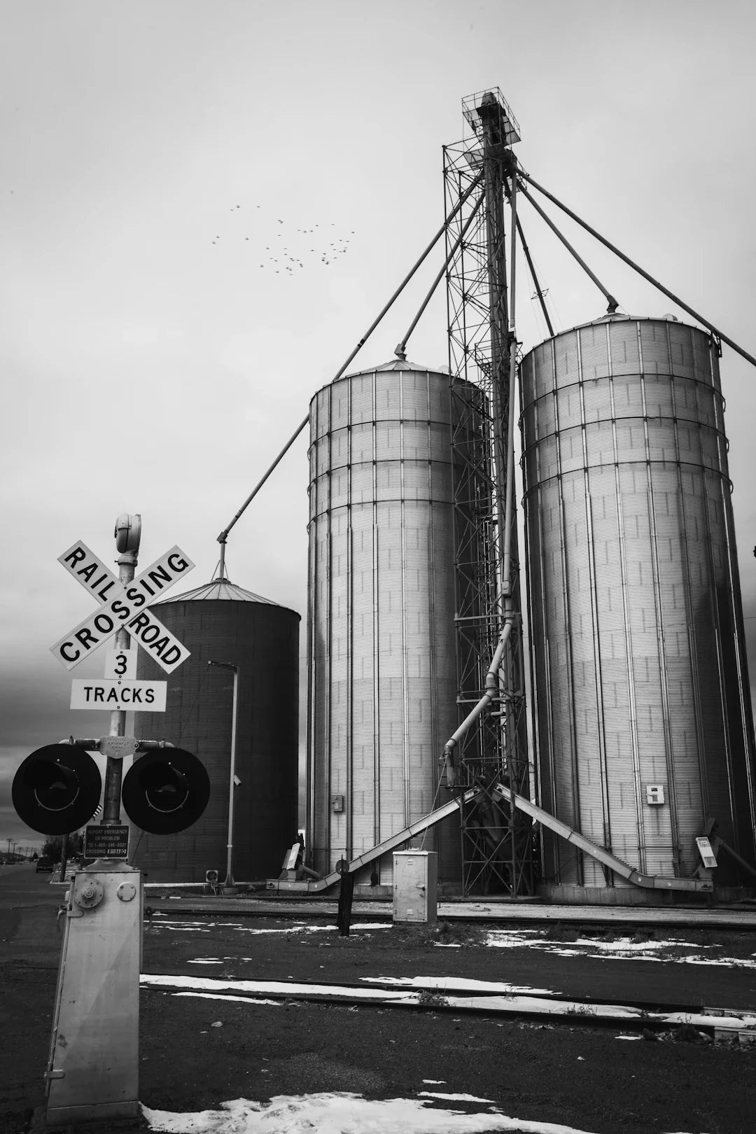 Railroad crossing signal with crossbuck sign in an article on American Dream and technological advancements