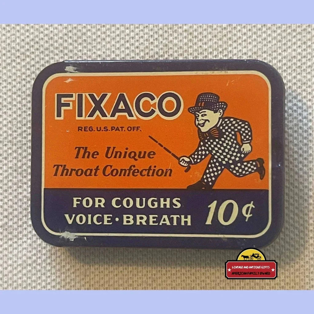 Vintage FIXACO throat lozenge tin with orange and navy lithographed design and vaudeville mascot art