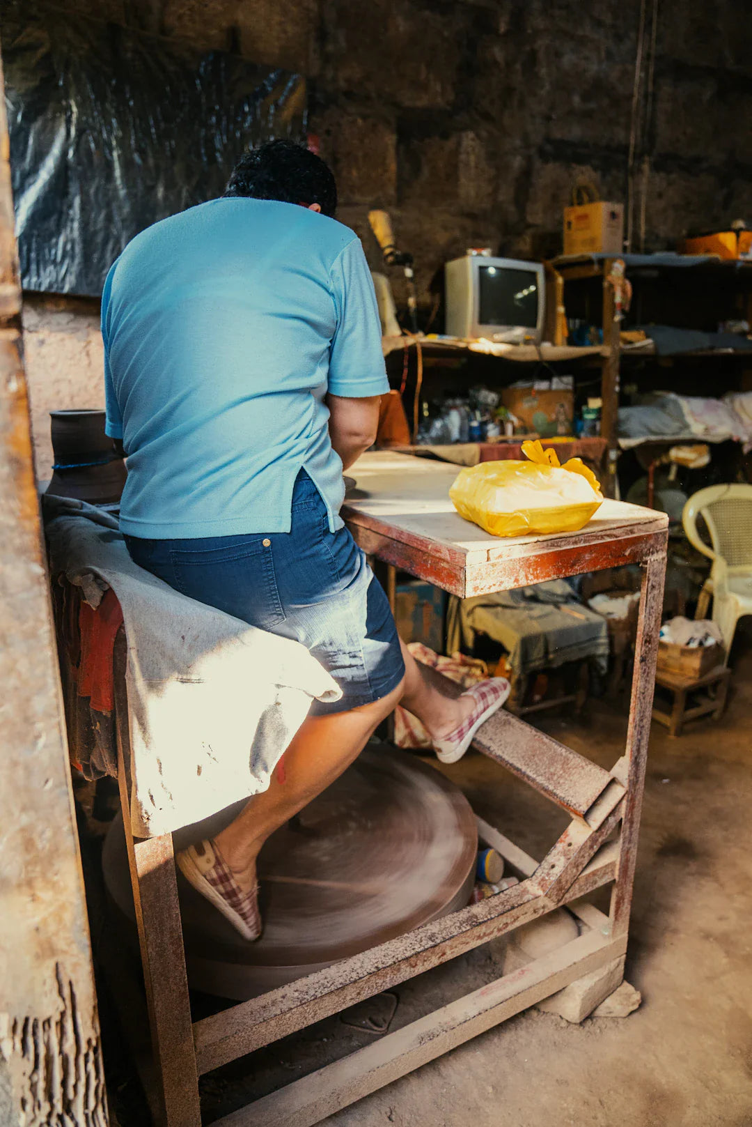 Artisan shaping clay on pottery wheel in craftsmanship shift