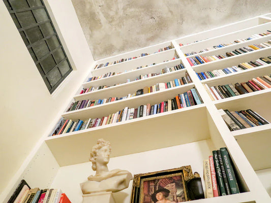 Tall white bookshelf with Harry Potter, Underground Railroad, and Secret History books