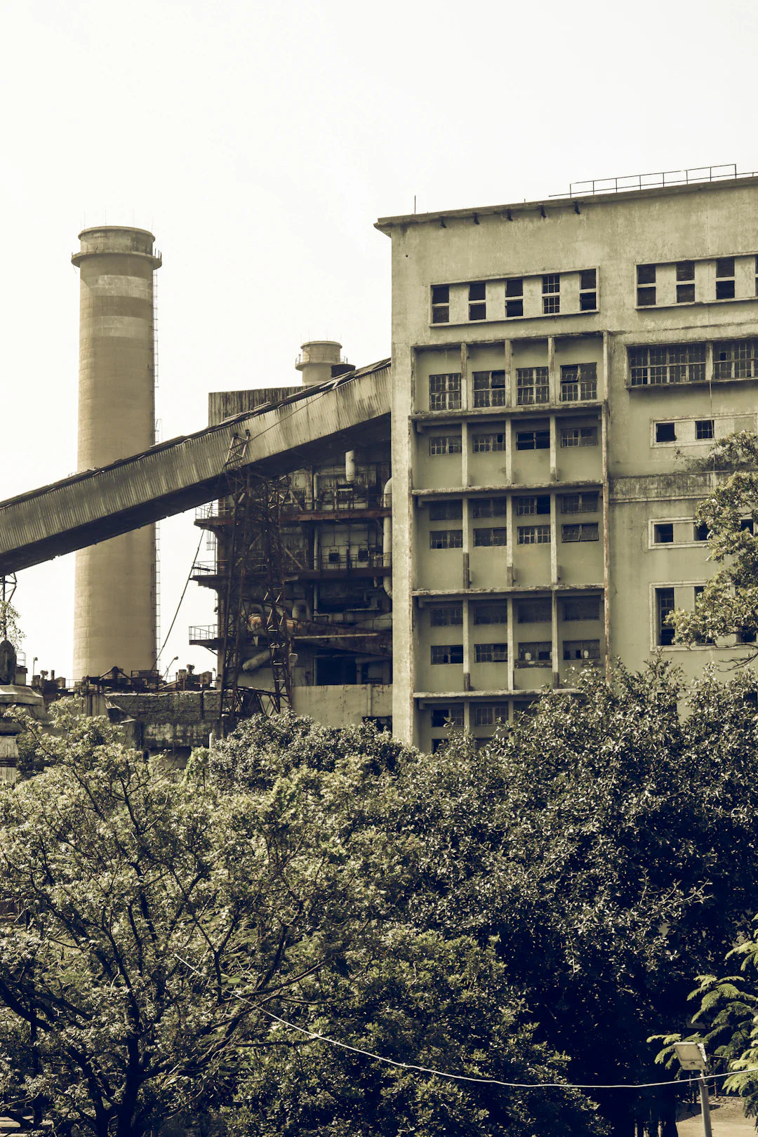 Old industrial factory with chimney and conveyor belt showcasing American industrial revolution