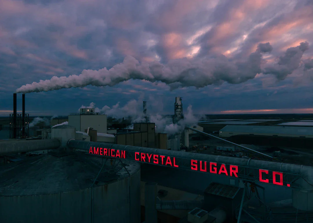 Industrial sugar plant with smokestacks, part of major industries in digital transformation